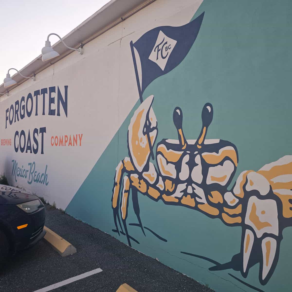 Forgotten Coast Brewing Company mural with a crab holding a blue flag