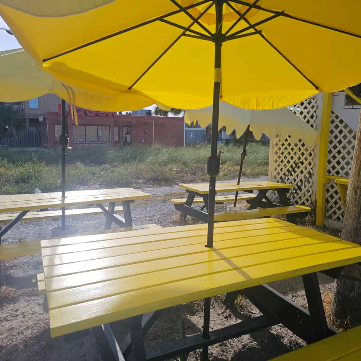 Yellow picnic tables with bright yellow umbrellas