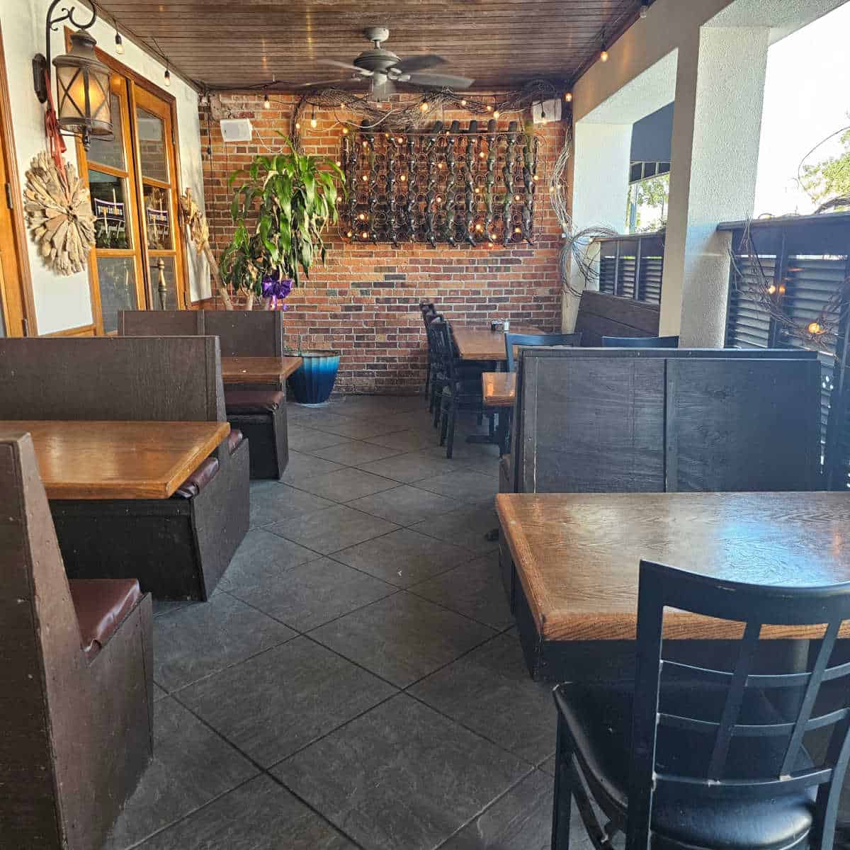 outdoor covered patio seating with booths with leather benches and tables