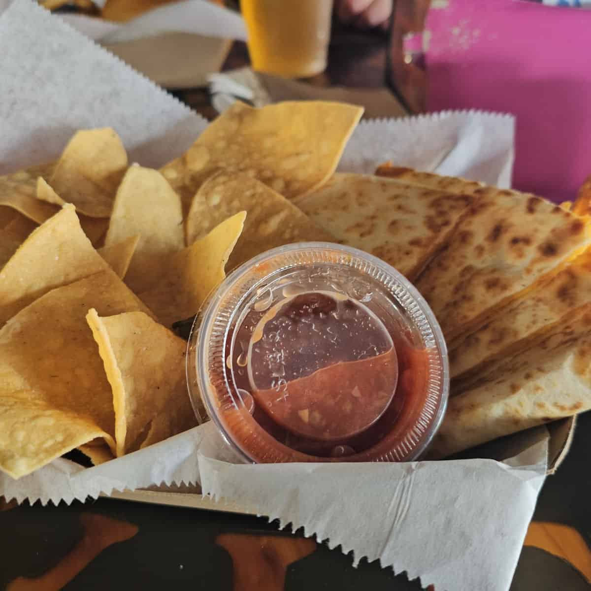 quesadilla chips and salsa in a paper lined basket