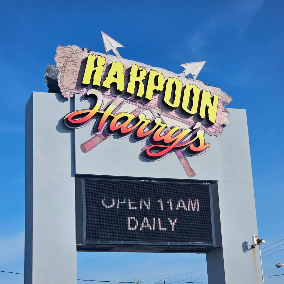 harpoon harry's sign with open 11am daily on it