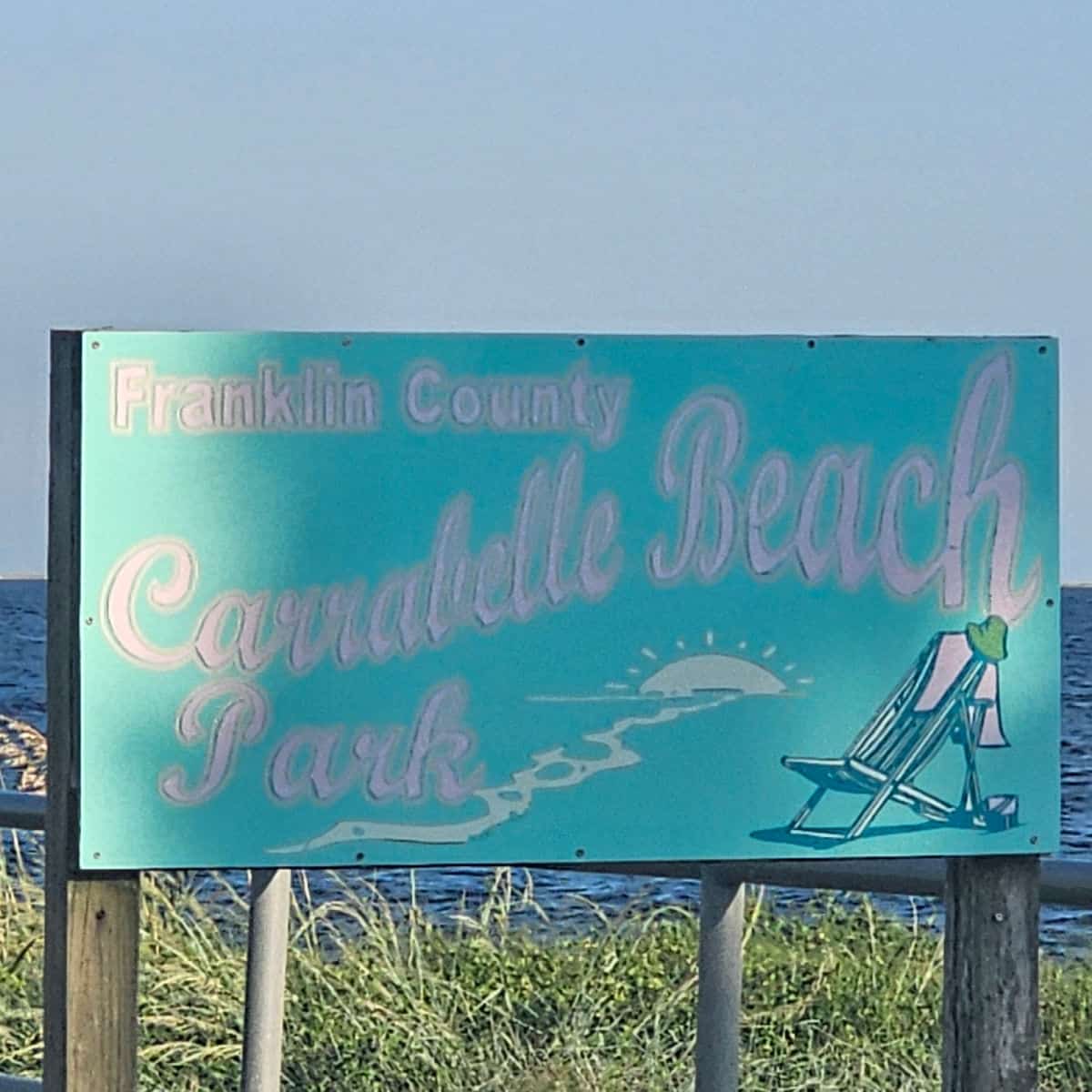 Franklin County Carrabelle Beach park sign with lawn chair on it