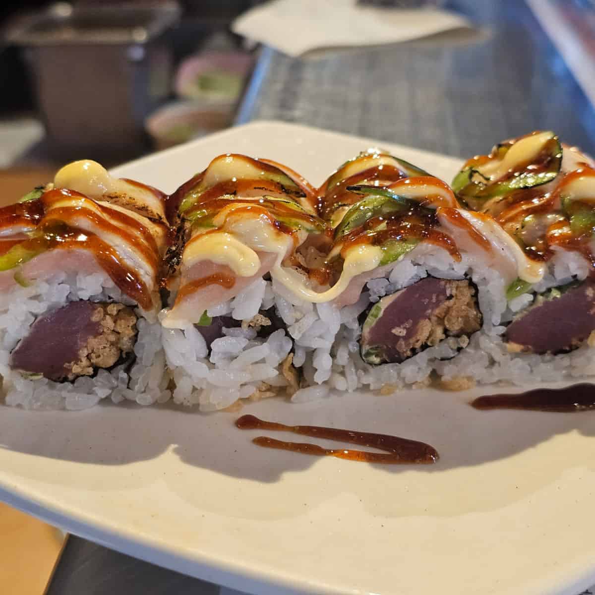 sushi in a row on a white plate