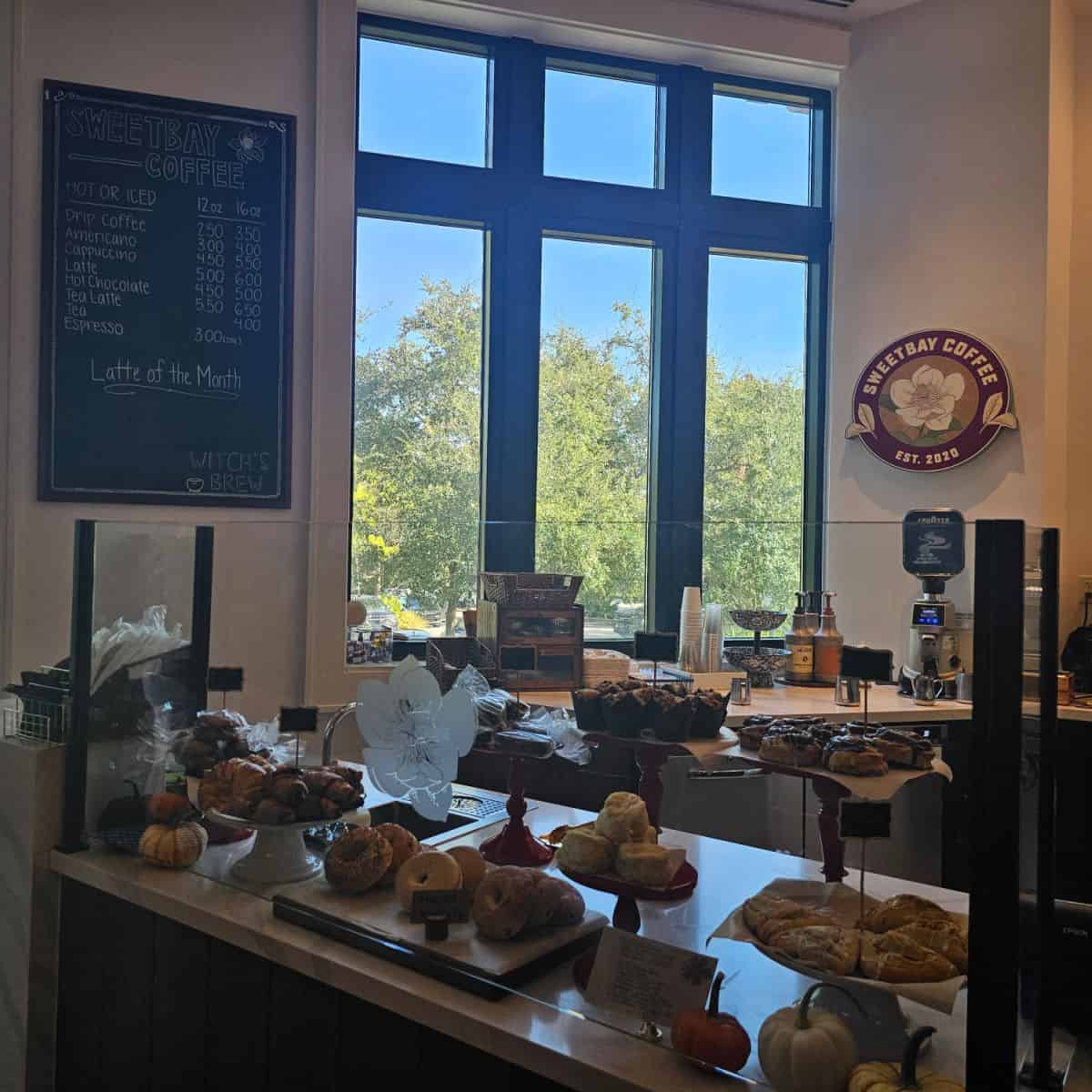 Sweetbay Coffee with menu on the wall, pastries displayed behind glass, coffee making equipment on back counter