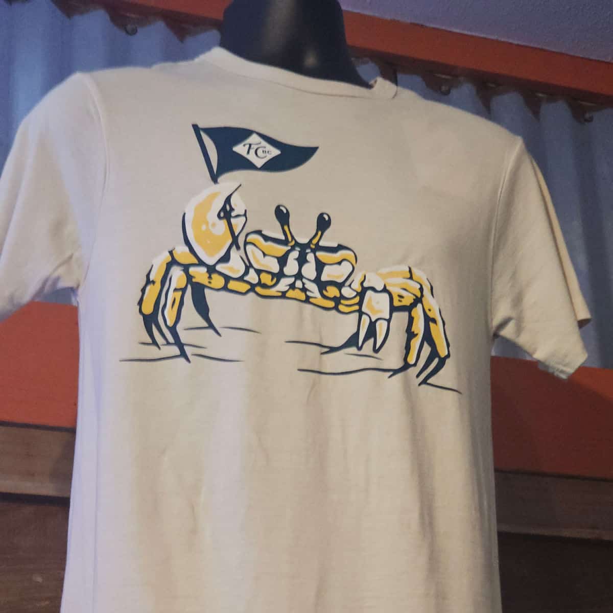 grey shirt with a ghost crab on it holding a flag