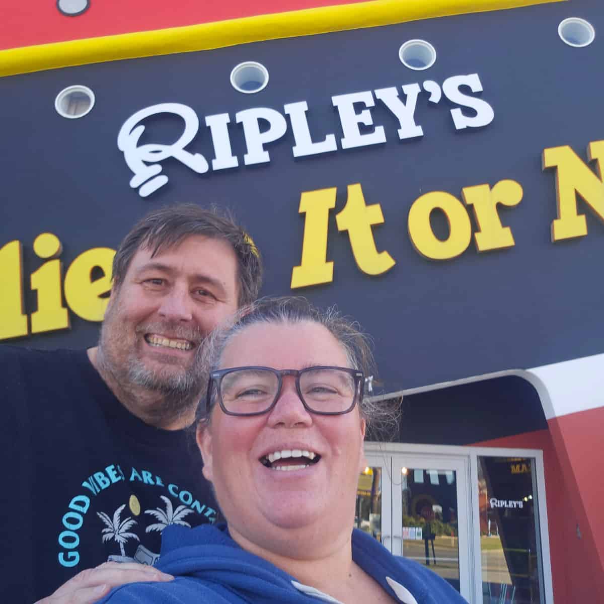 Tammilee and John in front of Ripley's Believe it or Not sign on the side of a boat