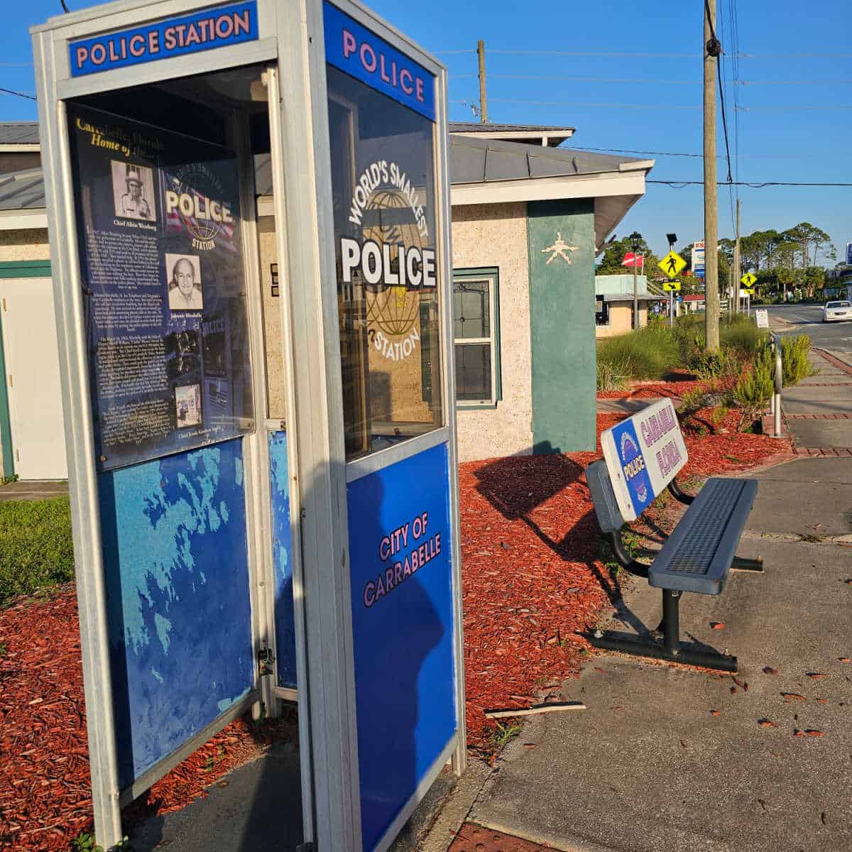 World's Smallest Police Station phone booth next to a park bench