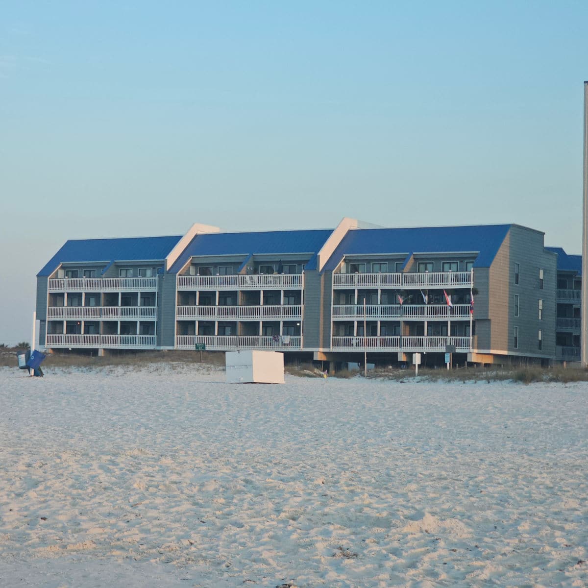 looking over the sand to the Regatta condo building with a blue roof