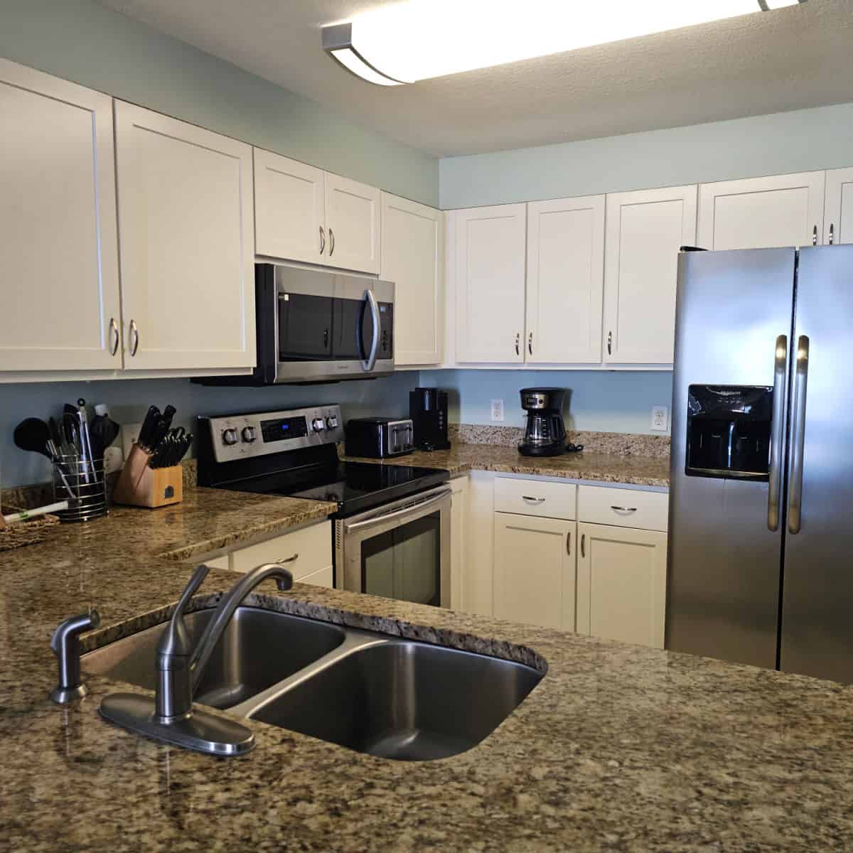 Kitchen with white cabinets and stainless steel appliances