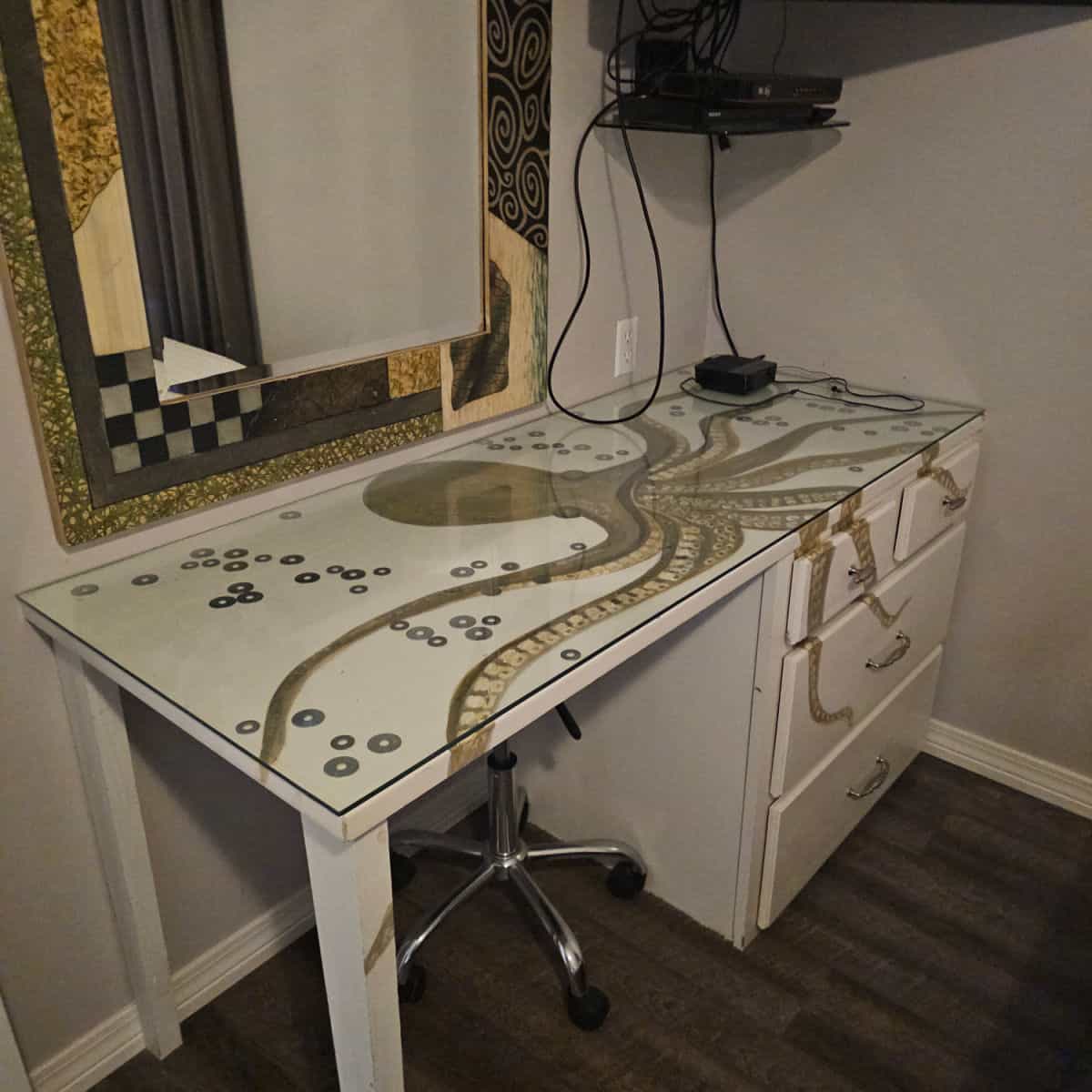 white desk with an octopus painted on it, mirror over the desk