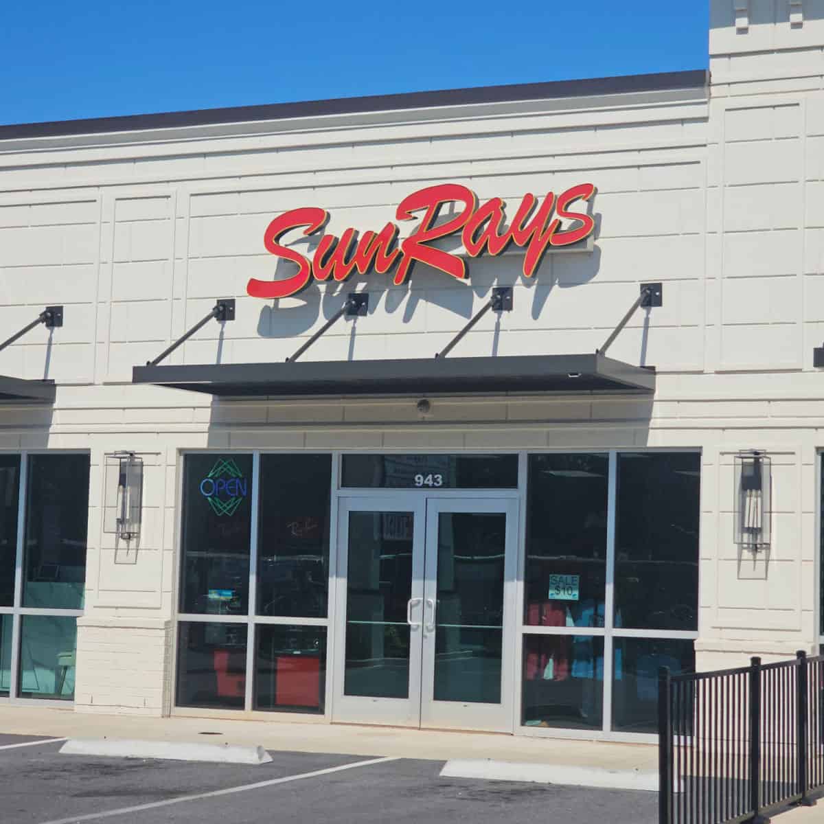 SunRays sign over the glass door entrance to the store in a shopping complex