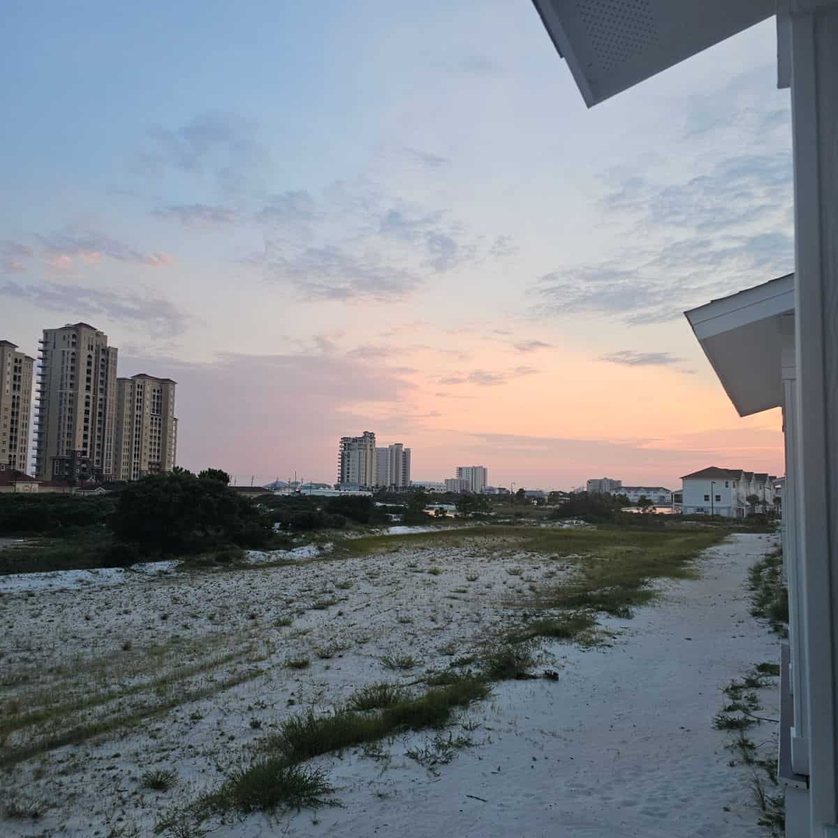 Sunset view looking out over the sand and tall buildings