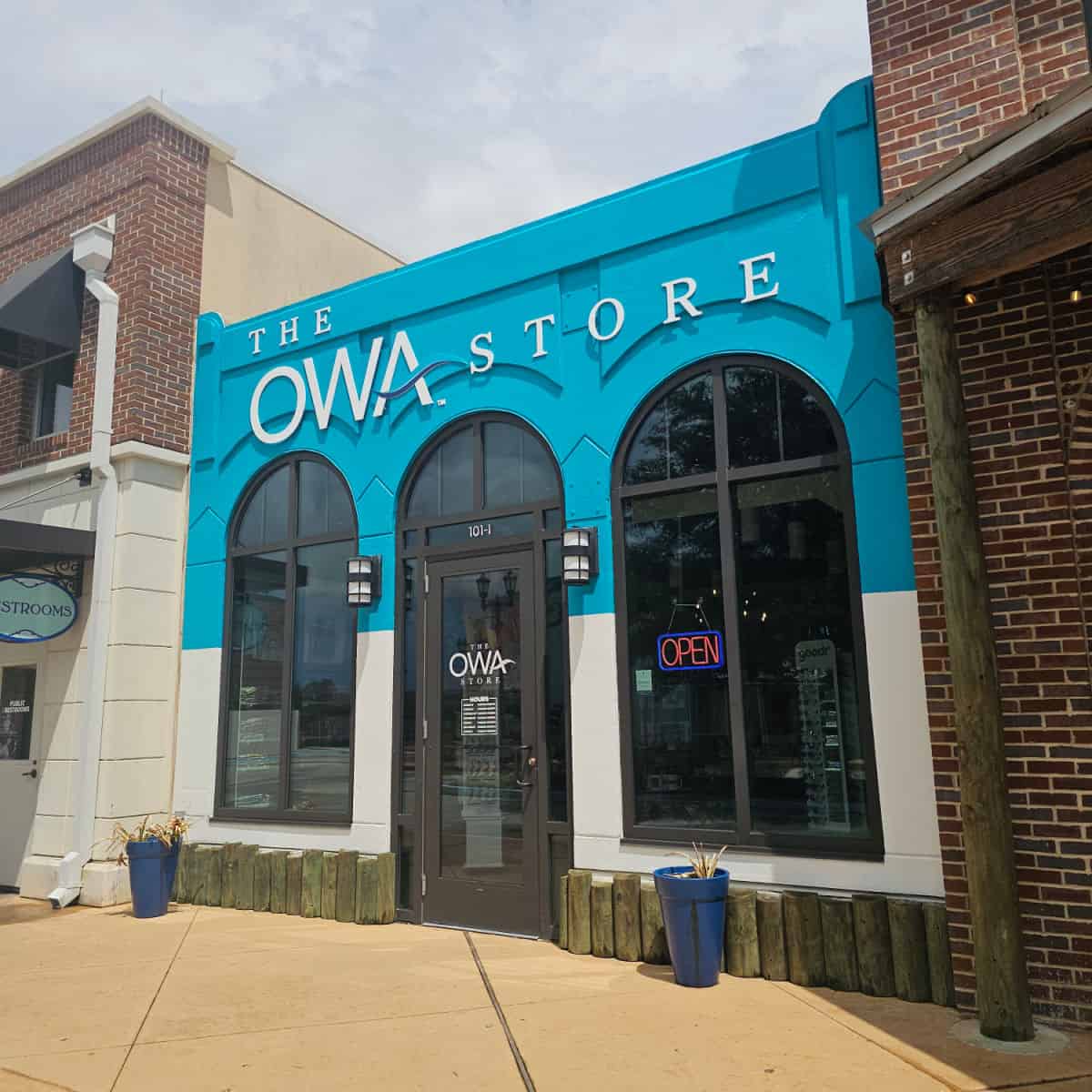 The OWA store sign over the entrance to the store