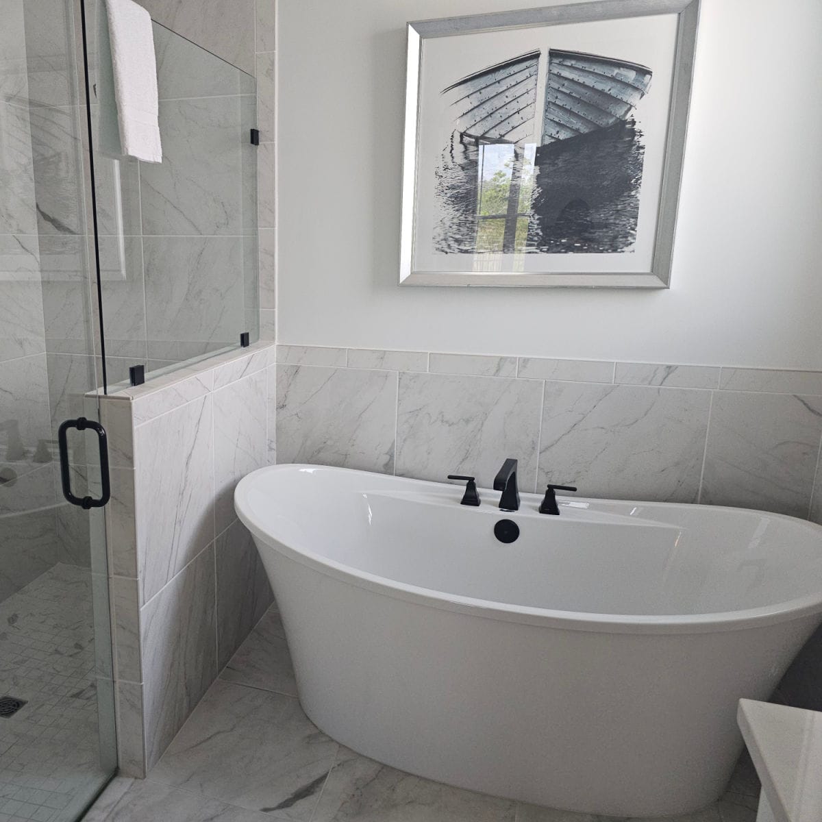 large white soaking tub next to a walk in shower