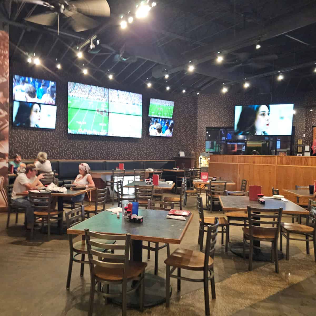 Baumhowers indoor seating with large tvs on the wall with football