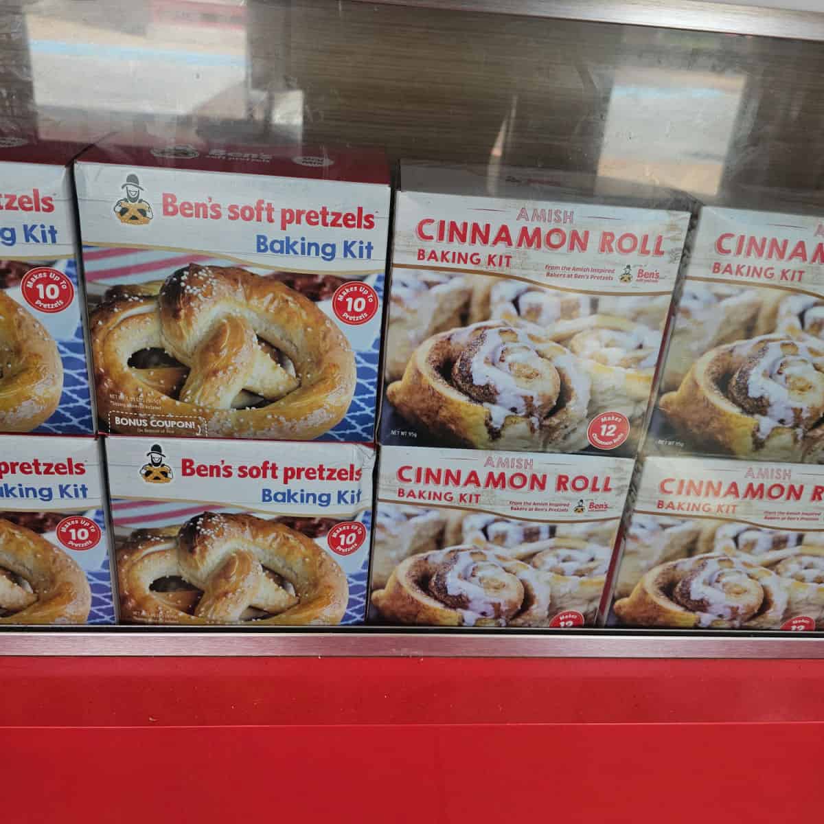 Ben's Soft Pretzels and Amish Cinnamon Roll baking kits in boxes lined up below the counter