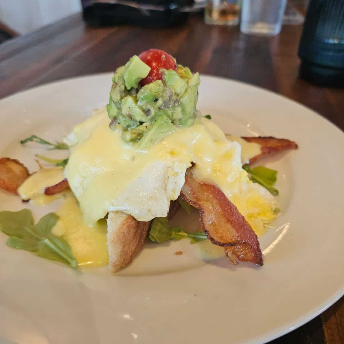 avocado toast with bacon and an egg on it, avocado and tomato crown