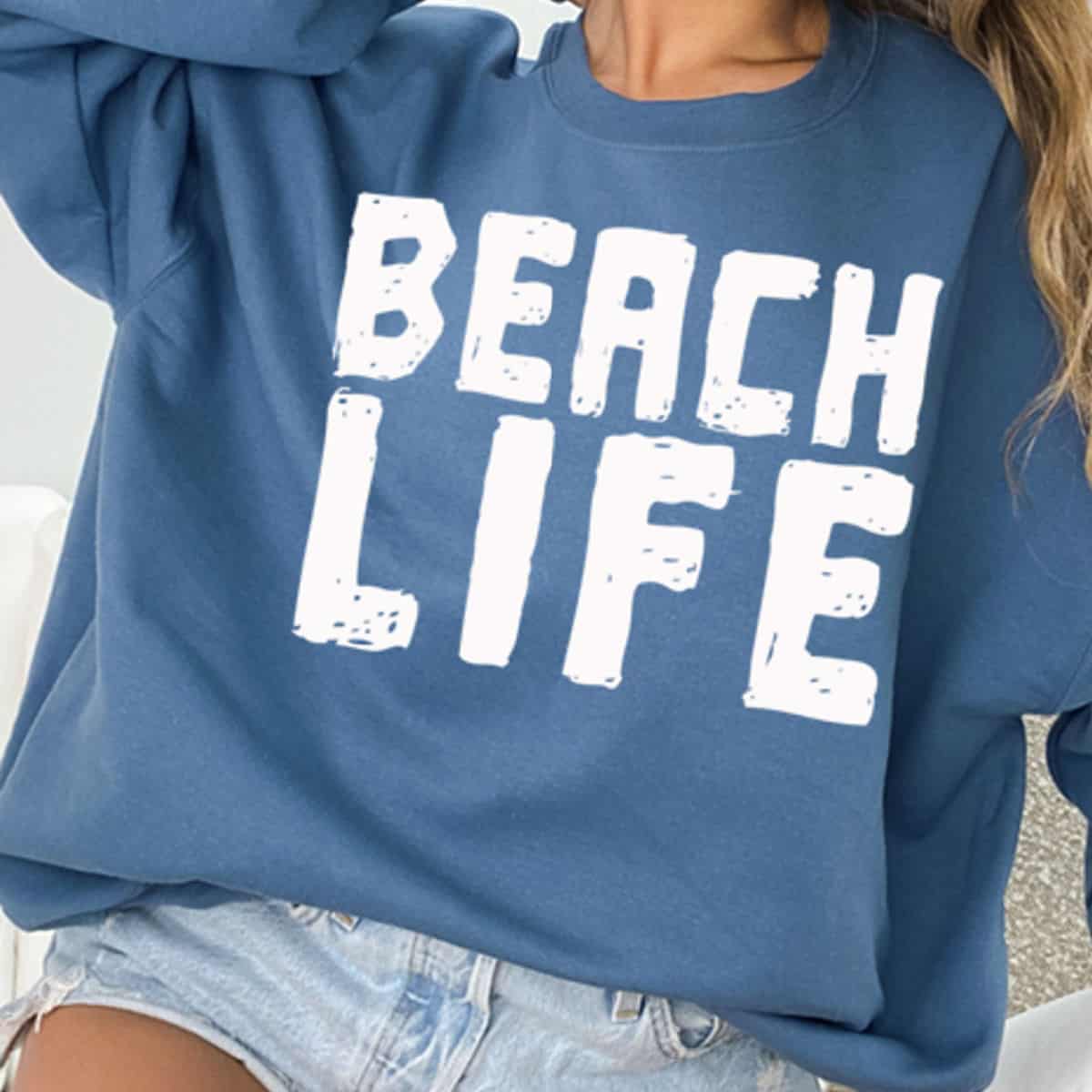 Blue sweatshirt with Beach Life printed on it
