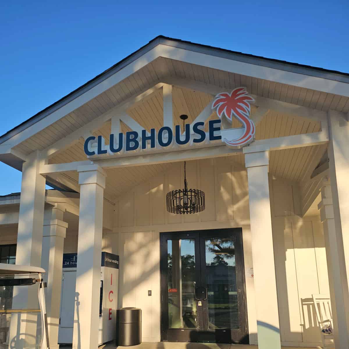 Clubhouse sign over the entrance to the building, ice machine near the entrance