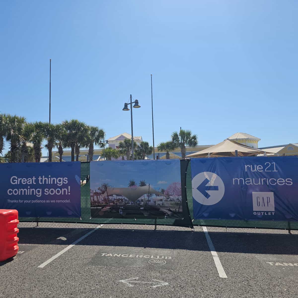Tanger Outlets great things coming soon sign with photo and store names
