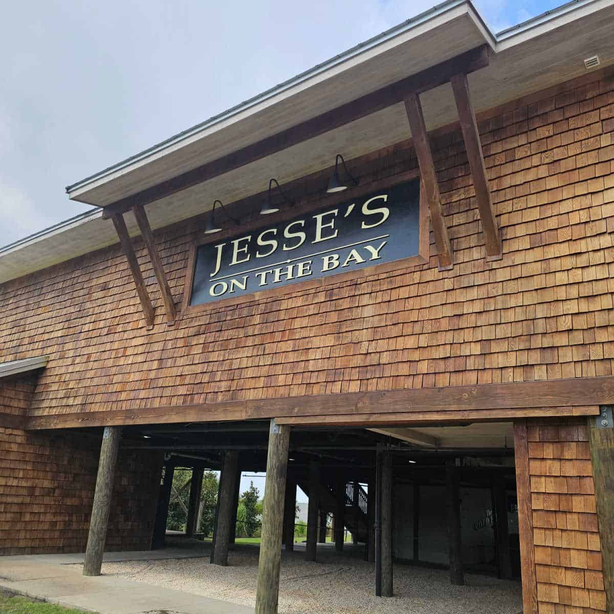 Jesse's on the Bay sign on a brown wood building with space under it