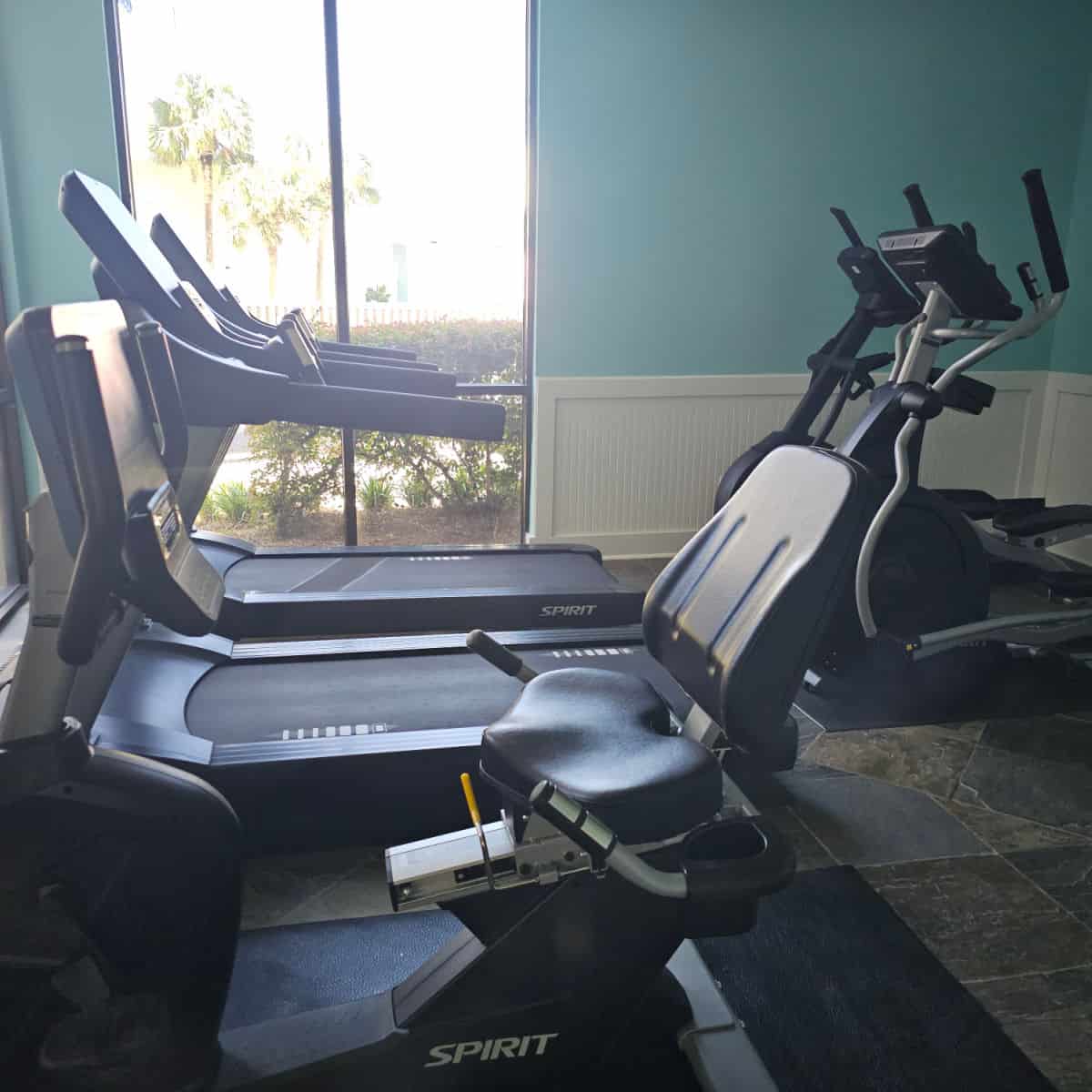fitness center with treadmills, a stationary bike, and ellipticals