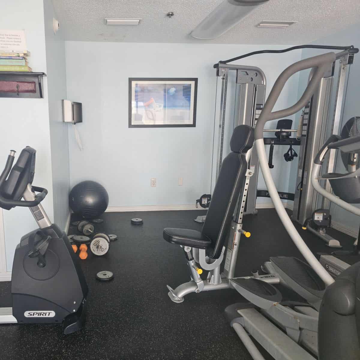 fitness center with a bike, weight machines and eliptical