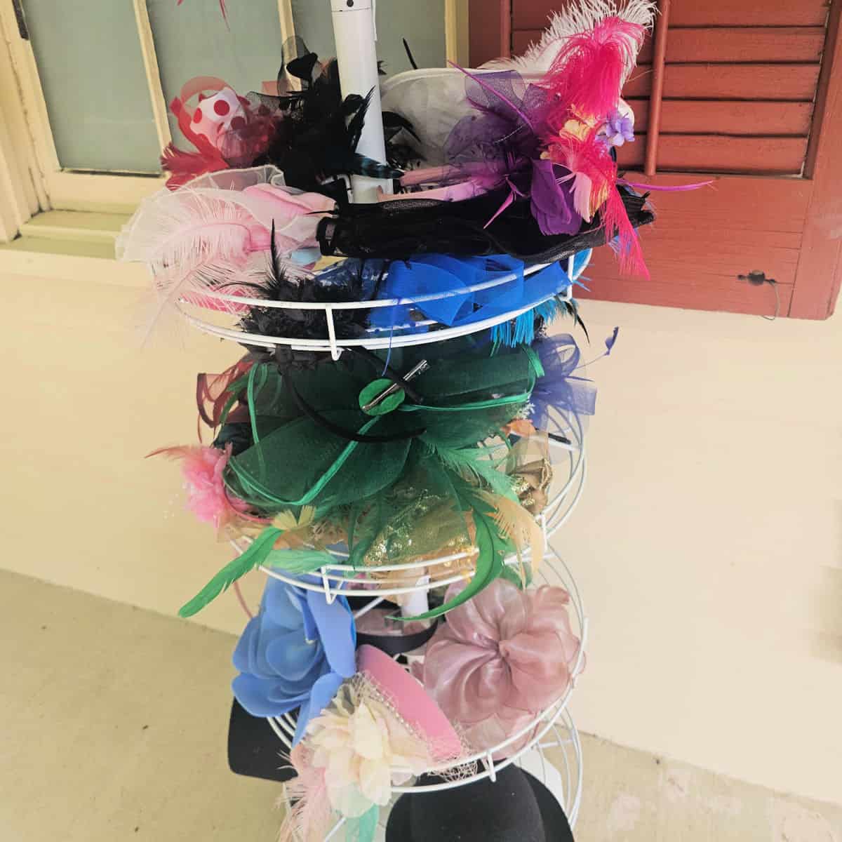 stand with fascinator hats on it