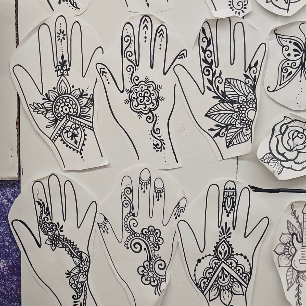 Henna full hand designs on a wall