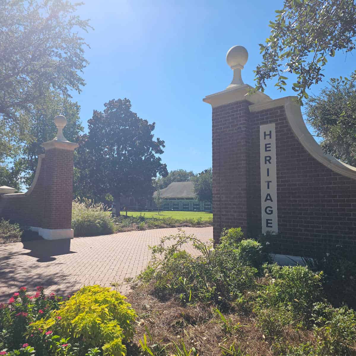 Heritage sign on the side of a brick entrance wall to the park