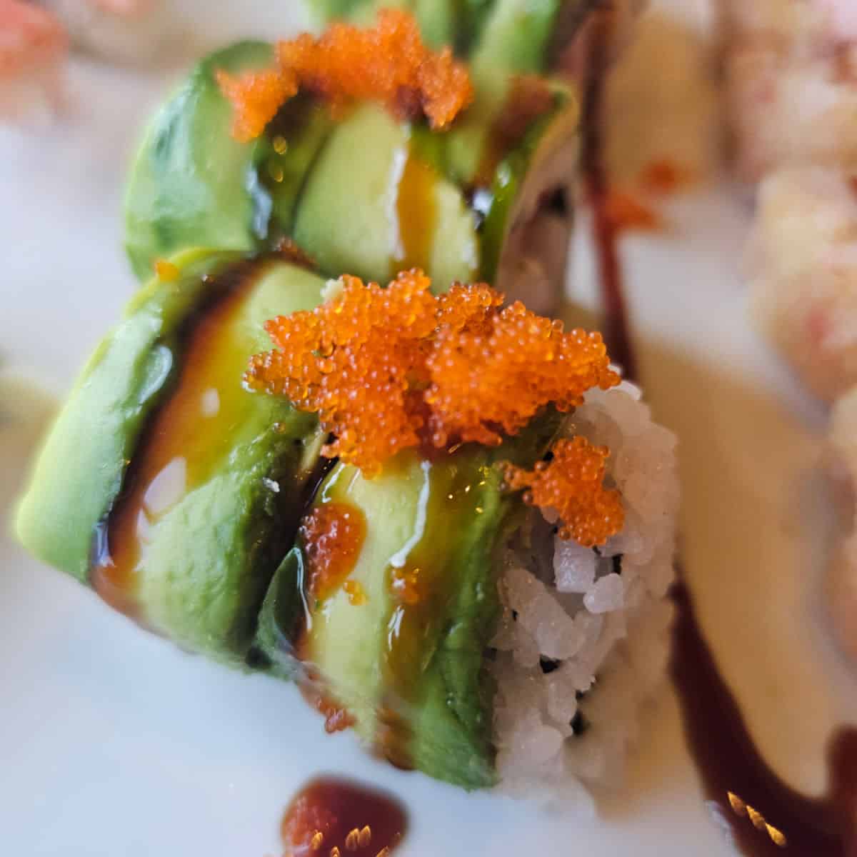 sushi roll with kani on top