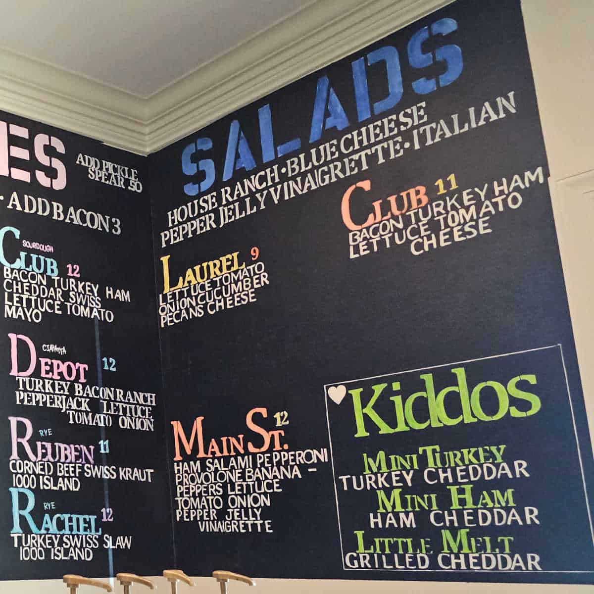 salads menu on chalkboard and kiddos menu