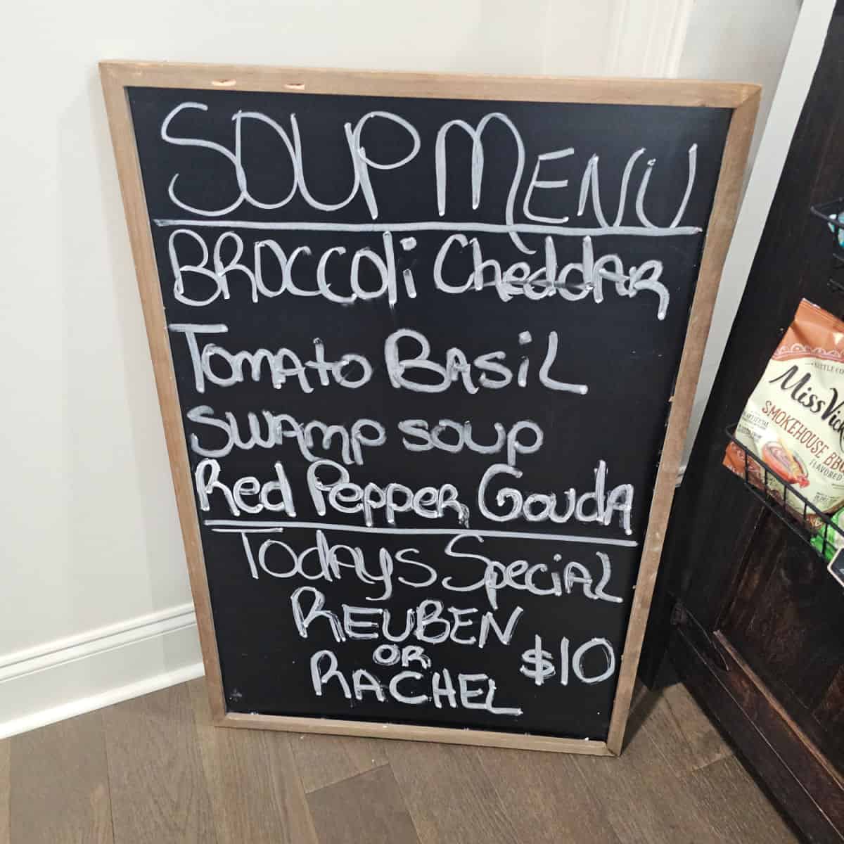 Soup menu with broccoli cheddar, tomato basil, swamp soup, red pepper gouda, and today's special of reuben or rachel