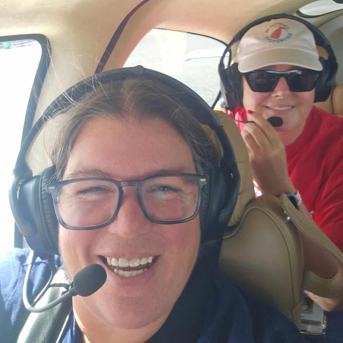 Tammilee and Brandy smiling wearing headphones