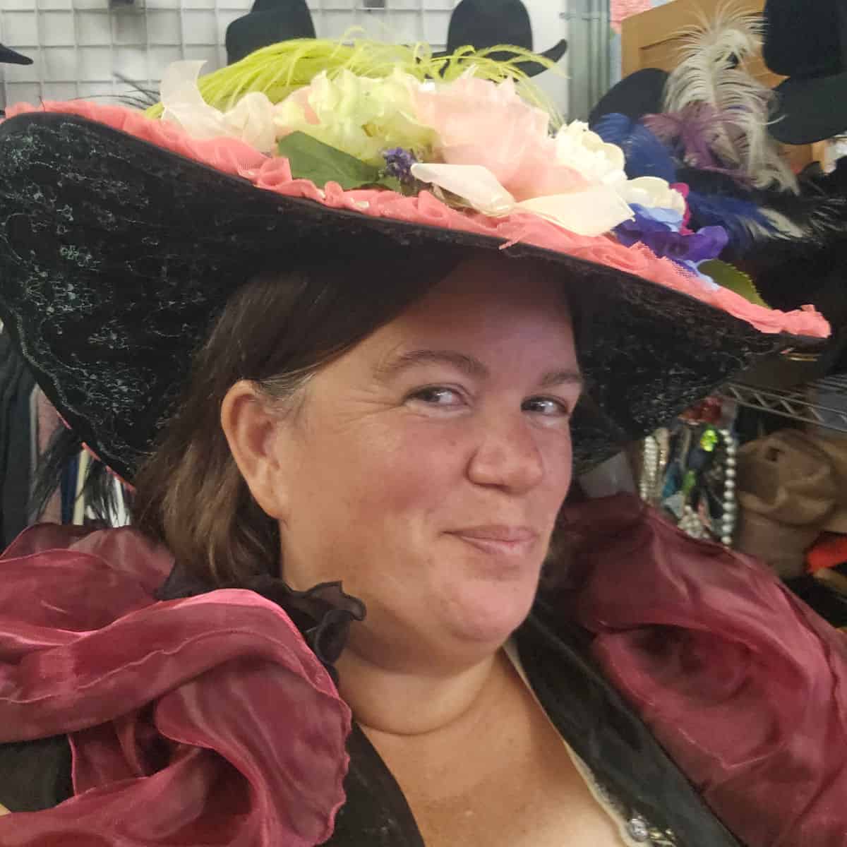 Tammilee wearing a pink floral hat and dress for old time photos