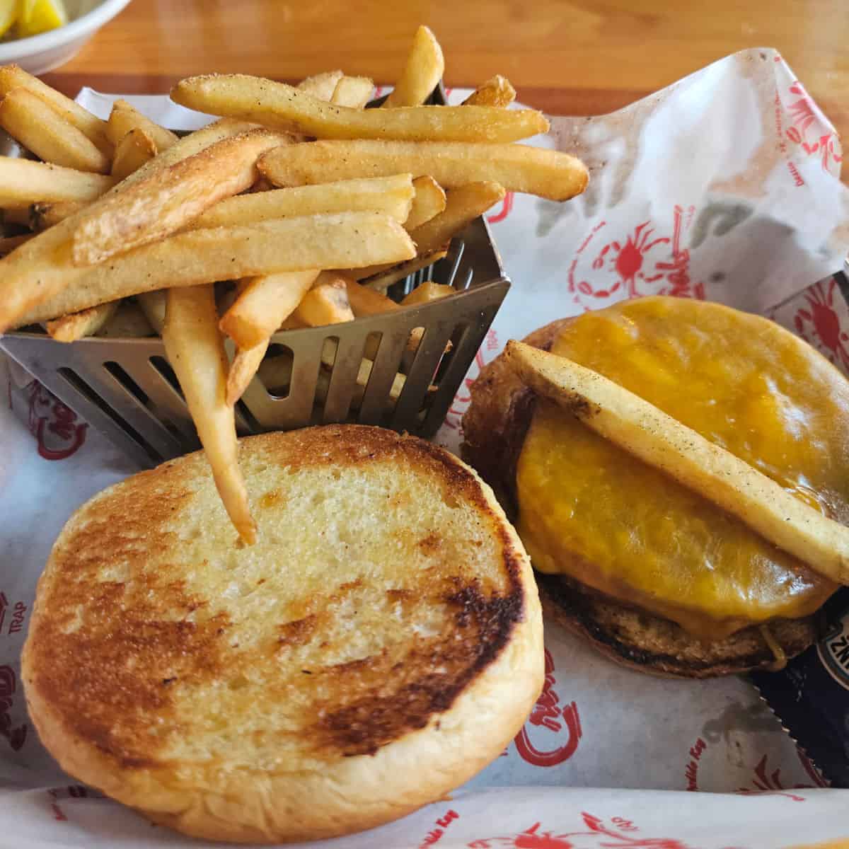 veggie burger in a paper lined tray with a basket of fries