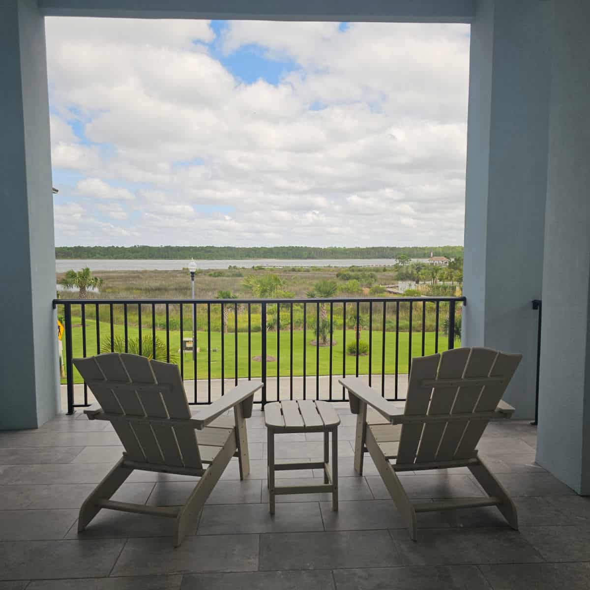 2 Adirondack chairs on the deck looking out towards Little Lagoon