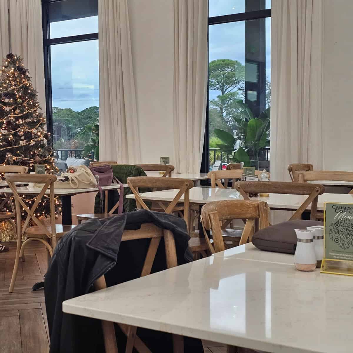 indoor seating with tables and chairs, christmas tree in the corner