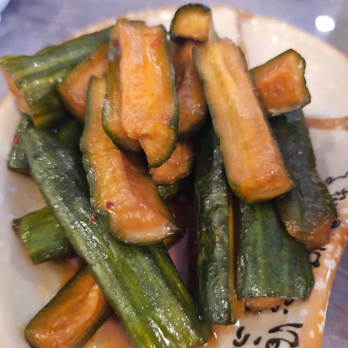 Spicy cucumber salad on a white plate