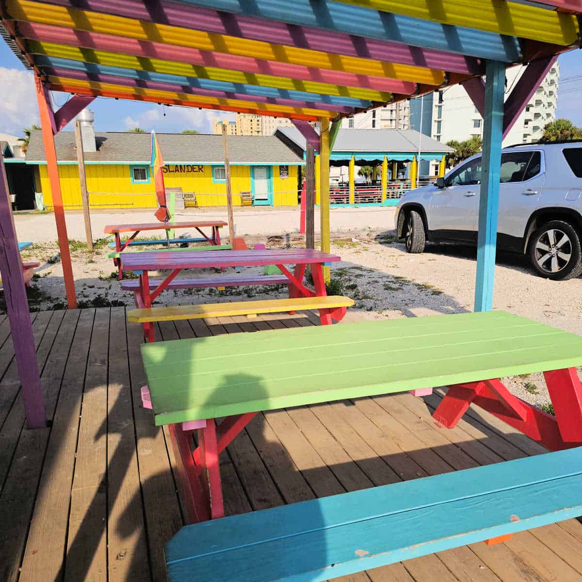 colorful picnic tables next to the building