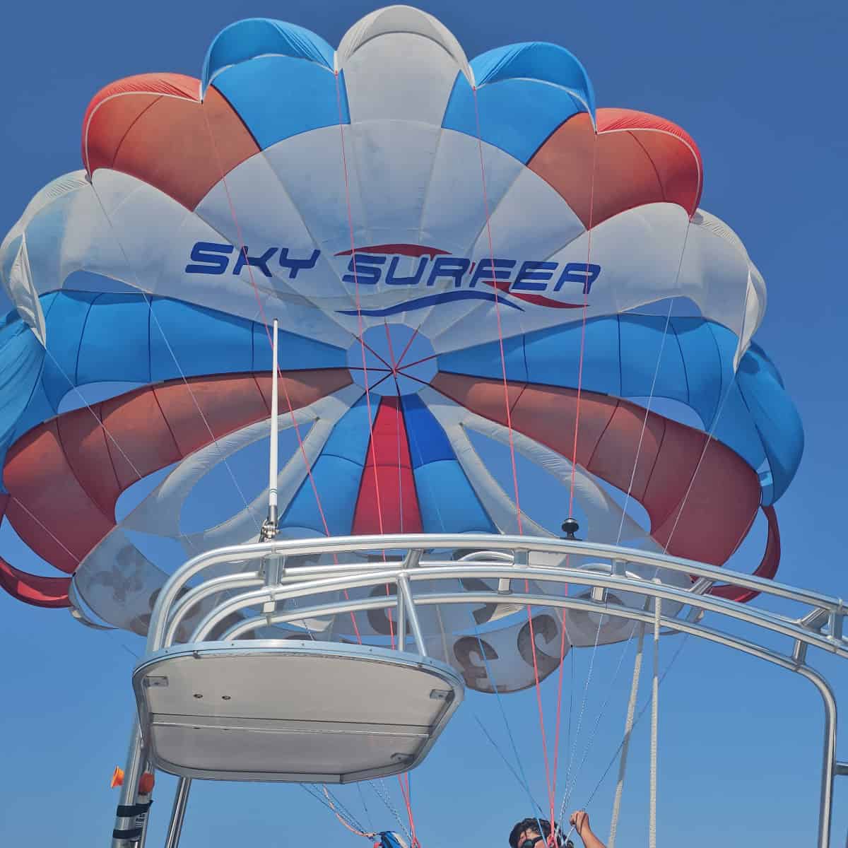 Sky Surfer red white and blue parachute above the boat