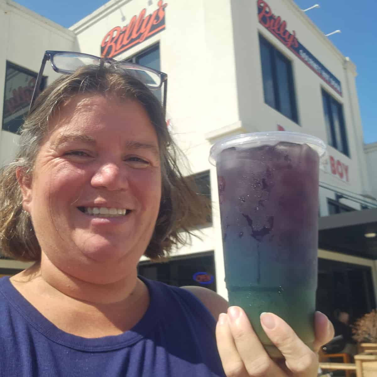 Tammilee holding a colorful tea drink